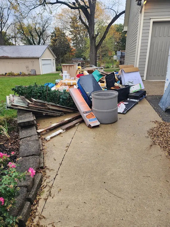 Dumpster being loaded with debris for Roofing Dumpster Rental in Eielson AFB